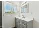 Bright bathroom with gray vanity, white countertop, and a window providing natural light at 428 E Kachina Trl, Phoenix, AZ 85042