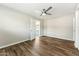 Clean bedroom with wood-look floors, neutral walls and an open door providing natural light at 428 E Kachina Trl, Phoenix, AZ 85042