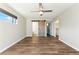 Bright bedroom featuring modern ceiling fan, natural lighting, and stylish sliding barn door at 428 E Kachina Trl, Phoenix, AZ 85042
