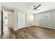 Nicely finished bedroom features wood-look flooring, neutral walls, and a ceiling fan at 428 E Kachina Trl, Phoenix, AZ 85042