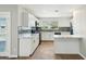 White kitchen featuring modern appliances, backsplash, marble countertops, and ample cabinet space at 428 E Kachina Trl, Phoenix, AZ 85042