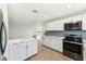 Bright kitchen featuring stainless appliances, white cabinetry, and a stylish backsplash at 428 E Kachina Trl, Phoenix, AZ 85042