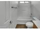 Bathroom featuring a tub shower, toilet and a door with a sleek black handle at 43530 W Eddie Way, Maricopa, AZ 85138