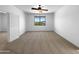 Spacious bedroom with neutral carpeting, a ceiling fan, and a large window at 43530 W Eddie Way, Maricopa, AZ 85138