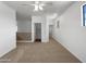 Spacious bonus room featuring a ceiling fan, neutral carpet and bright white walls and trim at 43530 W Eddie Way, Maricopa, AZ 85138
