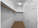 A walk-in closet featuring carpet flooring, shelving and a light for added convenience at 43530 W Eddie Way, Maricopa, AZ 85138
