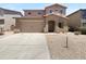 Charming two-story home with a large driveway, desert landscaping, and attached garage at 43530 W Eddie Way, Maricopa, AZ 85138
