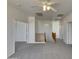 Upstairs hallway with plush carpeting and wooden banister at 43530 W Eddie Way, Maricopa, AZ 85138