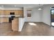 An eat-in kitchen with black appliances, light colored cabinets and tile floor at 43530 W Eddie Way, Maricopa, AZ 85138