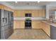 Well-lit kitchen with stainless steel appliances and ample cabinetry for storage at 43530 W Eddie Way, Maricopa, AZ 85138