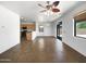 Open-concept living room featuring tile flooring and a ceiling fan with easy access to the kitchen at 43530 W Eddie Way, Maricopa, AZ 85138
