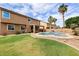 Expansive backyard showcasing a lush lawn, sparkling pool, and inviting patio area at 462 W Myrtle Dr, Chandler, AZ 85248
