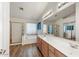 Spacious bathroom boasts double sinks, wood-look flooring, and a separate shower and tub at 462 W Myrtle Dr, Chandler, AZ 85248