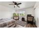 Simple bedroom with ceiling fan, window, and a cozy seating area, creating a relaxing atmosphere at 462 W Myrtle Dr, Chandler, AZ 85248