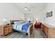 Bright bedroom with wood-look floors, light walls, a ceiling fan, and comfortable furniture at 462 W Myrtle Dr, Chandler, AZ 85248
