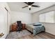 Functional bedroom features a desk area, closet, and a comfortable bed, ideal for relaxation and work at 462 W Myrtle Dr, Chandler, AZ 85248