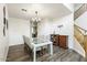 Dining room featuring wood-look floors, a modern chandelier, and seating for eight at 462 W Myrtle Dr, Chandler, AZ 85248