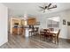 Open kitchen with an island, eat-in bar, light wood cabinets, and wood-look flooring at 462 W Myrtle Dr, Chandler, AZ 85248