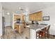 Bright kitchen with light wood cabinets, an island, stainless appliances, and counter seating at 462 W Myrtle Dr, Chandler, AZ 85248