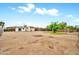 Large dirt backyard with shed, wooden fence, and partial tree coverage at 508 S Pasadena --, Mesa, AZ 85210