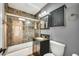 Stylish bathroom featuring tiled shower and flooring, modern vanity, and elegant fixtures at 508 S Pasadena --, Mesa, AZ 85210