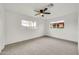 Spacious bedroom features neutral carpet, dual windows, and a ceiling fan for added comfort at 508 S Pasadena --, Mesa, AZ 85210