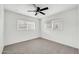 Well-lit bedroom with dual windows, neutral carpet, and a ceiling fan for added comfort at 508 S Pasadena --, Mesa, AZ 85210