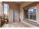 Balcony featuring tiled flooring, exterior door, window with modern louvers, and garden for serene outdoor living at 5350 E Deer Valley Dr # 3274, Phoenix, AZ 85054