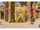 Well-maintained building entrance with palm trees, rock detail, and mature landscaping at 5350 E Deer Valley Dr # 3274, Phoenix, AZ 85054