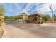Gated community entrance with guardhouse, manicured landscaping, and well-maintained street at 5350 E Deer Valley Dr # 3274, Phoenix, AZ 85054