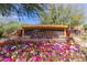 Inviting Toscana community sign surrounded by vibrant, colorful flowers and lush greenery, enhancing curb appeal at 5350 E Deer Valley Dr # 3274, Phoenix, AZ 85054