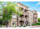 Multi-level condominium featuring stone accents, balconies, and manicured landscaping at 5350 E Deer Valley Dr # 3274, Phoenix, AZ 85054