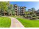 Well-maintained apartment building with manicured lawn, walkway, and lush landscaping, creating inviting outdoor space at 5350 E Deer Valley Dr # 3274, Phoenix, AZ 85054