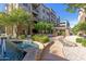 Scenic view of community apartments with water feature, landscaping, and winding walkway, creating resort-style atmosphere at 5350 E Deer Valley Dr # 3274, Phoenix, AZ 85054
