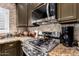 Stainless steel gas range with microwave and decorative tile backsplash at 5350 E Deer Valley Dr # 3274, Phoenix, AZ 85054