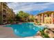 Large resort-style pool surrounded by lounge chairs and lush landscaping at 5350 E Deer Valley Dr # 3274, Phoenix, AZ 85054