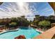 Resort-style pool surrounded by upscale apartment buildings, palm trees, and lounge chairs for relaxed outdoor living at 5350 E Deer Valley Dr # 3274, Phoenix, AZ 85054