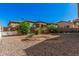 Low-maintenance backyard featuring gravel, plants, and a block fence for privacy at 5808 E Lawndale St, Mesa, AZ 85215