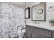 Well-lit bathroom features a modern vanity, large mirror, and shower with elegant accents at 5808 E Lawndale St, Mesa, AZ 85215