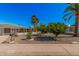 Charming home with a well-maintained front yard featuring desert landscaping and mature trees at 5808 E Lawndale St, Mesa, AZ 85215