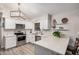 Bright kitchen featuring modern white cabinets, stainless steel appliances, and quartz countertops at 5808 E Lawndale St, Mesa, AZ 85215