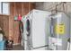 Functional laundry room with washer, dryer, and water heater at 5808 E Lawndale St, Mesa, AZ 85215