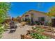 Spacious backyard with a garden, patio, outdoor seating, lush landscaping and privacy fence at 6031 N Milano Ct, Litchfield Park, AZ 85340
