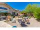 Backyard features a gravel area with a firepit and outdoor seating, vegetable garden and green landscaping at 6031 N Milano Ct, Litchfield Park, AZ 85340