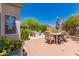 Private backyard with a patio, outdoor seating, and mature landscaping at 6031 N Milano Ct, Litchfield Park, AZ 85340