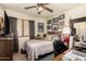 Comfortable bedroom with a ceiling fan, gallery wall and window at 6031 N Milano Ct, Litchfield Park, AZ 85340