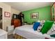 Bright bedroom featuring colorful pillows and a charming, vintage-style dresser at 6031 N Milano Ct, Litchfield Park, AZ 85340