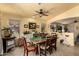Bright dining area featuring a wooden table, ceiling fan and vintage stove at 6031 N Milano Ct, Litchfield Park, AZ 85340
