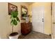 Inviting foyer with tiled floors, a wooden console table, and a decorative mirror at 6031 N Milano Ct, Litchfield Park, AZ 85340
