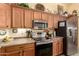 Updated kitchen featuring wood cabinets, stainless appliances, and generous counter space at 6031 N Milano Ct, Litchfield Park, AZ 85340